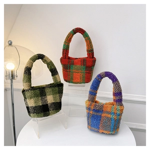 Detailed view of three checkered plush bucket bags in green, red, and blue autumn colors