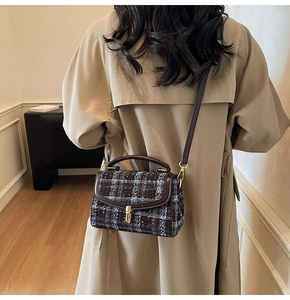 Brown tweed crossbody bag with vintage check pattern and leather trim on a model