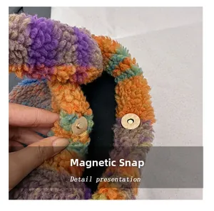 Detail of the golden magnetic snap closure on a colorful sherpa plaid plush handbag