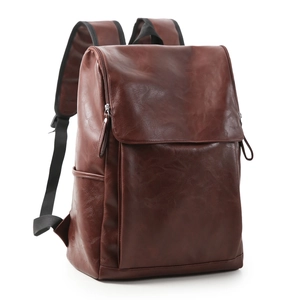Side view of a brown leather backpack showing textured PU material and flap closure design