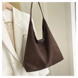 Side view of dark brown matte leather hobo bag with long shoulder strap and large capacity