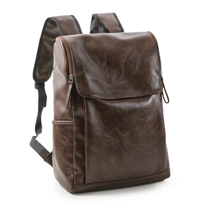 Detail view of dark brown retro leather backpack with side pockets and adjustable straps
