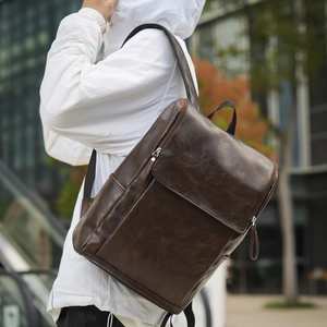 Detail of dark brown vintage leather backpack with lychee grain and silver hardware