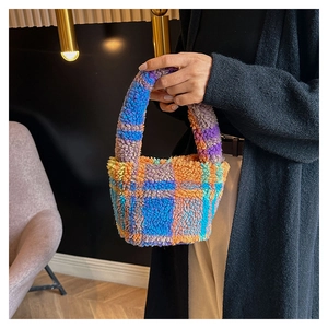 Detail of colorful plaid faux fur handbag with vibrant blue and orange plush texture