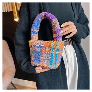 Detailed view of plush lamb wool bucket bag with colorful plaid pattern and soft texture