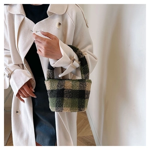 Detail of plush checkered handbag styled with a cream winter coat for a cozy casual look