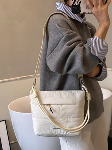White quilted nylon crossbody bucket bag with adjustable strap and top handle
