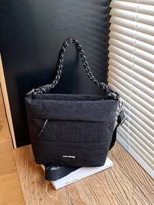 Minimalist black crinkle nylon tote bag with woven handles and aotuatbag logo print