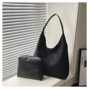 Minimalist black matte PU leather hobo bag with matching small zippered accessory pouch