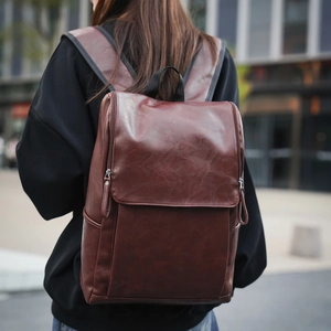 Detail of vintage dark brown leather backpack texture with vertical side zipper
