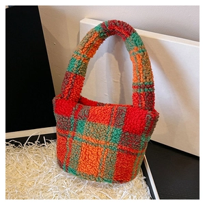 Detailed view of plush lamb wool tote with red, orange, and green checkered texture