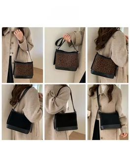 Detailed look at vintage leopard print and black suede tote bag with leather strap