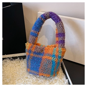Detail of colorful teddy fleece checkered tote bag with plush texture and vibrant pattern