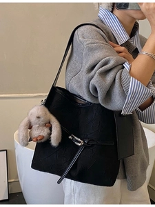Retro black pleated tote bag with silver buckle and plush bunny charm for daily wear