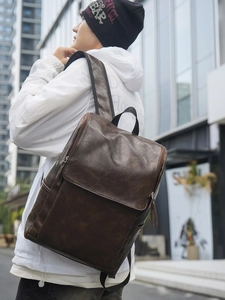 Classic dark brown PU leather backpack for men featuring a vintage flap and street style