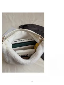 Top view of large capacity white plush tote bag showing spacious interior with books