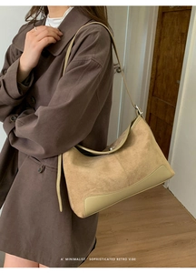 Close-up of minimalist beige matte and smooth leather patchwork shoulder bag for women