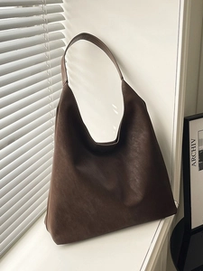 Minimalist large brown leather hobo tote bag for women commuting in casual style