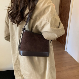 Vintage dark brown suede shoulder tote bag styled with a beige trench coat for autumn