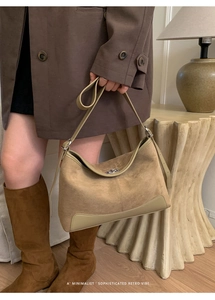 Detail of retro suede crossbody bag featuring khaki finish and silver twist-lock closure