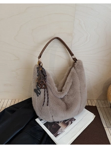 Detailed close-up of faux fur tote bag with leather handle and decorative pendant charm