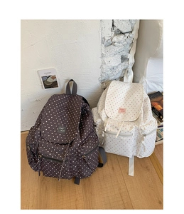 Detail of star pattern canvas backpacks with functional multi-zipper pockets and flap closure