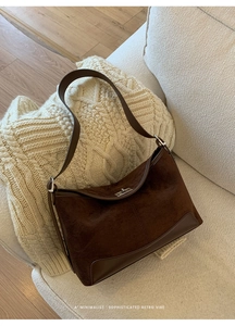 Detail showing retro brown suede and leather splicing with silver twist lock closure