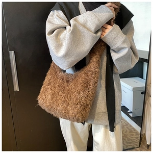 Detail shot of brown plush faux fur fabric texture on a seasonal bucket shoulder bag