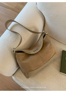 Detail showing vintage brown suede leather texture and silver twist lock on shoulder bag