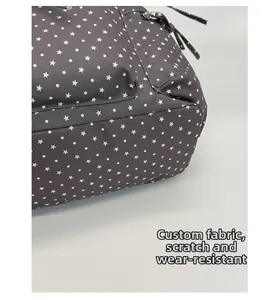 Macro view of scratch-resistant star pattern fabric on this durable travel backpack