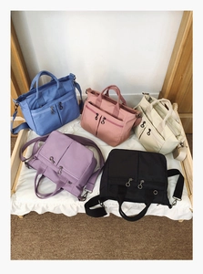 Collection of nylon multi-pocket crossbody bags in blue, pink, white, purple and black