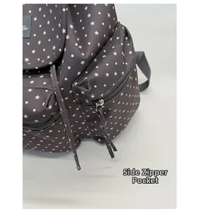 Detail shot of the side zipper pocket with long webbing puller on a starry backpack