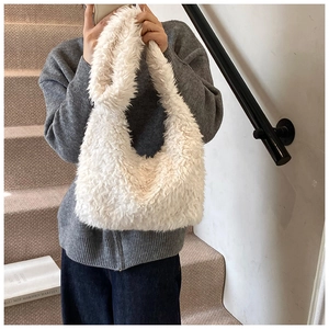 Detailed close-up showing soft white plush texture of the faux fur shoulder bag