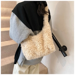 Chic cream faux fur shoulder bag worn by model, showcasing its soft plush texture and style