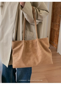 Close-up of retro matte khaki tote bag featuring minimalist stitching and soft suede texture