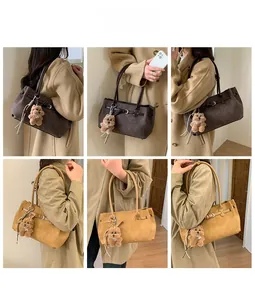 Brown suede tote bags styled with long trench coat and plush bear charm accessories