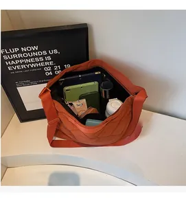 Internal view of quilted orange tote bag showing high capacity for tablets and essentials