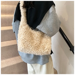 Close-up of fluffy faux fur bucket bag showing soft texture and cozy shoulder strap detail
