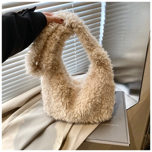 Detail of soft cream faux shearling plush handbag with fluffy texture and curved handle