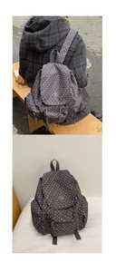Detail of grey star-patterned backpack with waterproof fabric and multi-pocket structure