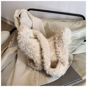 Close-up of the soft beige faux fur texture on this versatile plush crossbody bucket bag