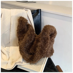 Detailed texture of brown curly faux fur on a fluffy autumn winter bucket bag