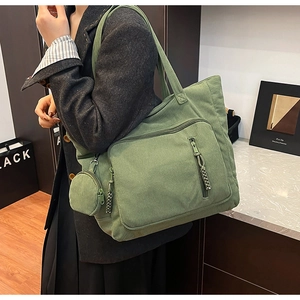 Dettaglio della borsa tote in velluto a coste verde con texture e mini borsa portamonete