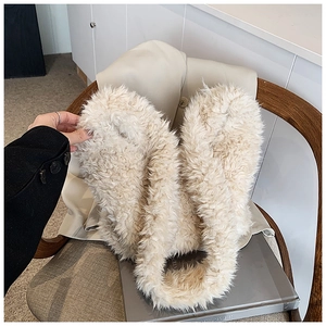 Close-up of the soft cream faux fur texture on the stylish plush bucket handbag