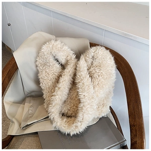 Detailed view of soft cream faux fur scarf shaped as heart on casual blazer