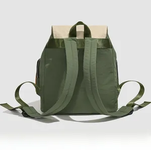 Detailed back view of a forest green waterproof nylon backpack with white flap and wide straps