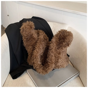 Macro detail of the plush brown faux fur texture on a stylish bucket handbag accessory