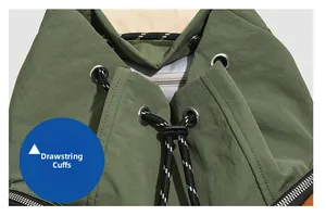 Macro detail of the drawstring closure on a dark green waterproof backpack with metal eyelets