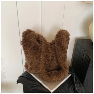 Detail of premium brown faux fur tote bag with fluffy texture and wide shoulder strap