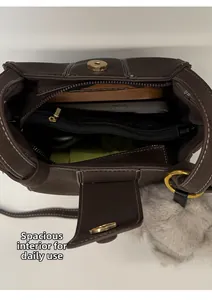Interior view of small brown leather bucket bag showing compartments and daily essentials
